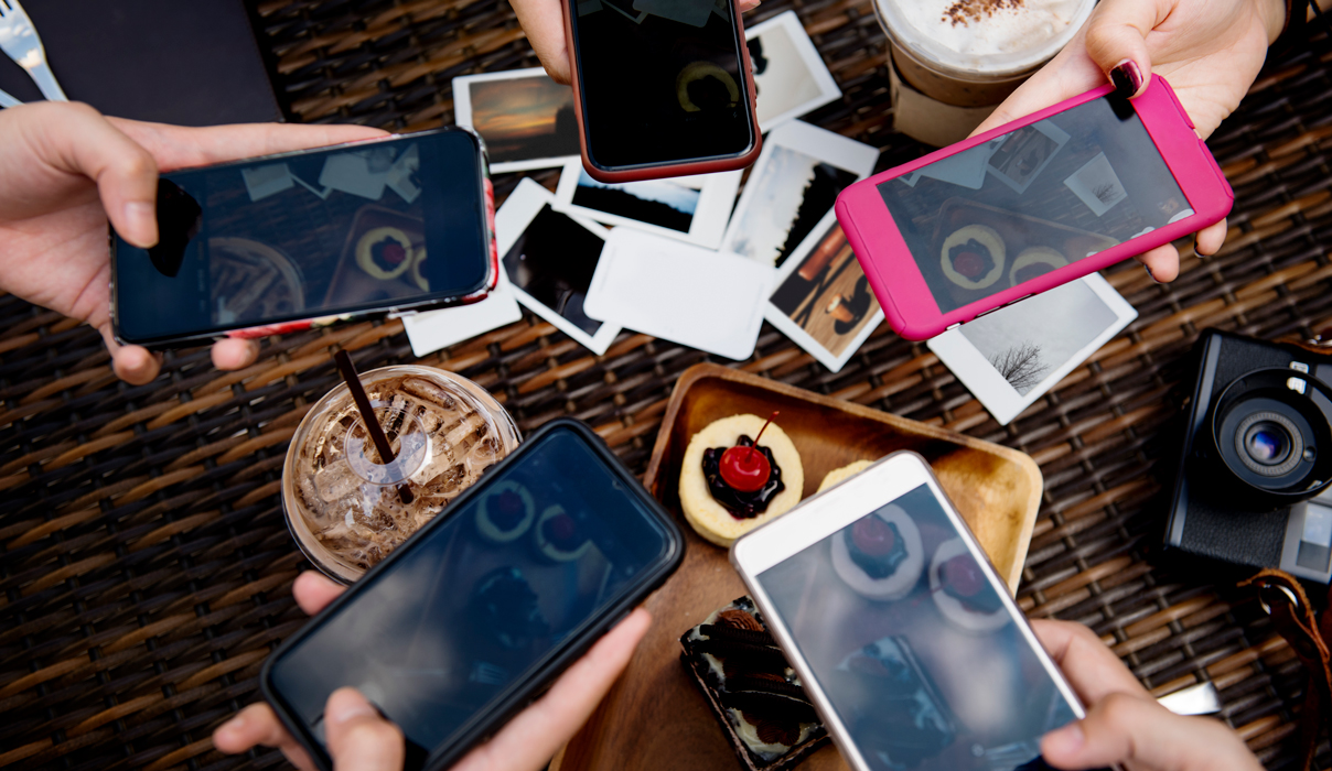 multiple mobile phones taking photos for social media