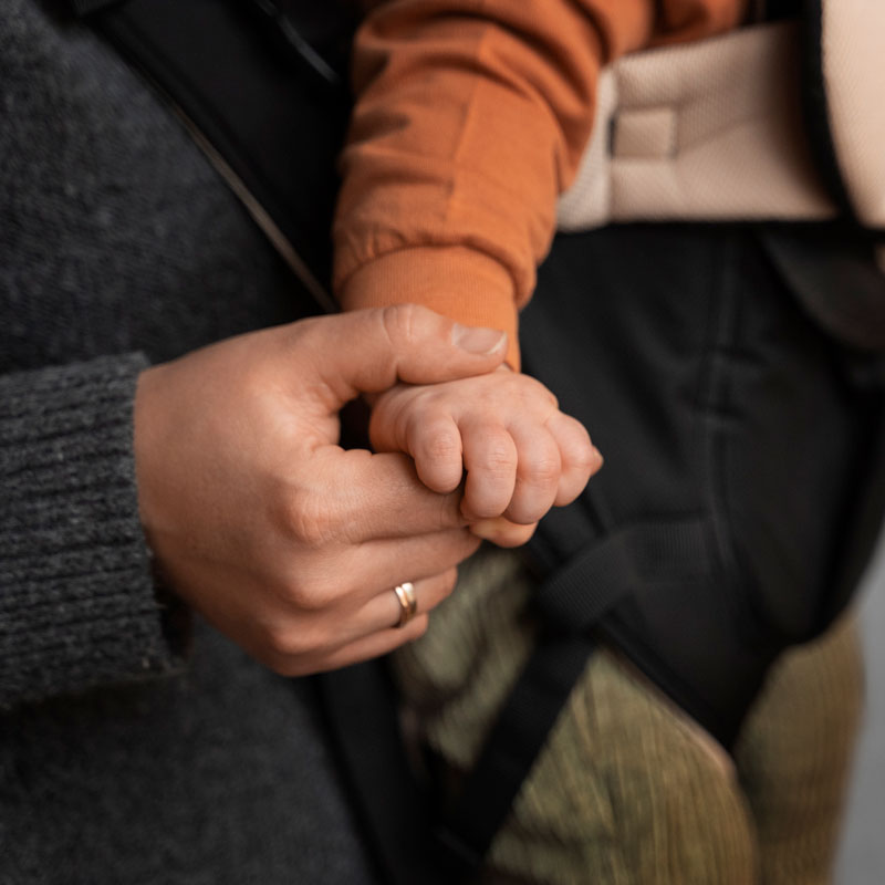 man holding a childs hands representing child support