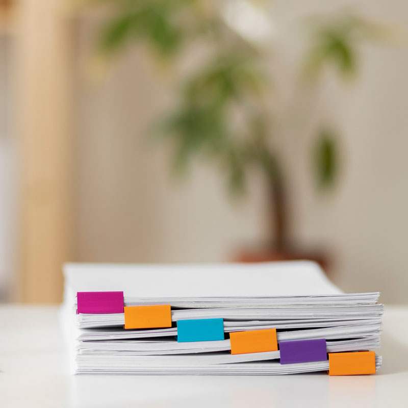 a stack of papers on a desk with different colored sections representing spousal support